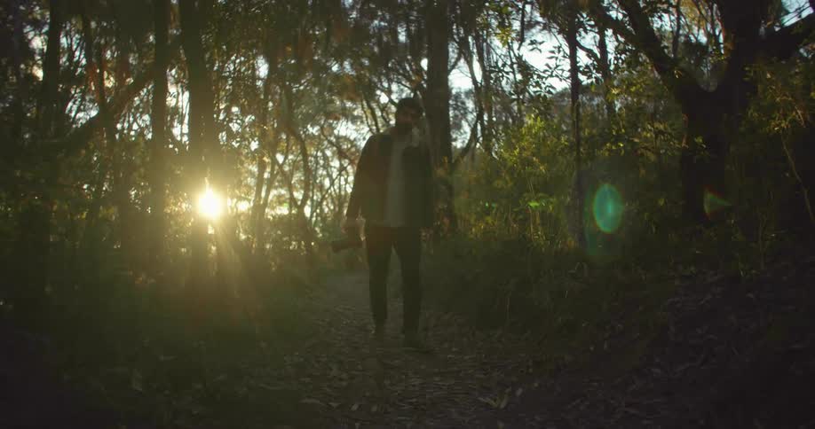 A man is hiking on the trail in the forest