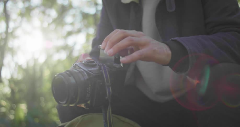 A man putting a cartridge into a camera