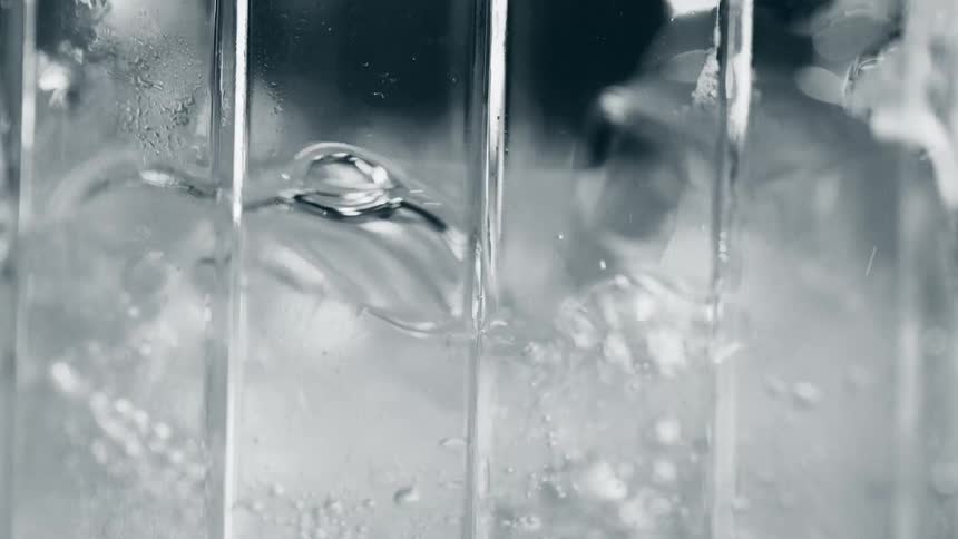 A bubbly beverage is poured over ice