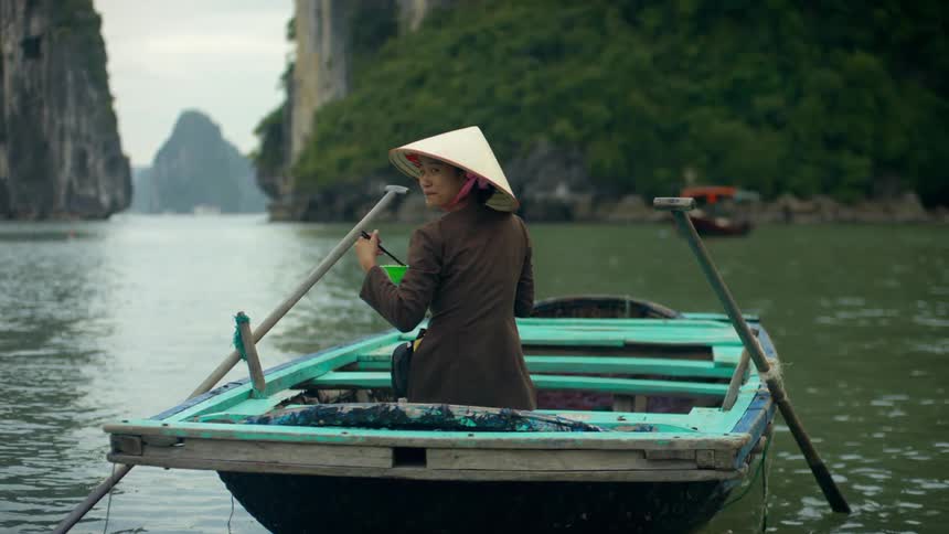 A woman that is in a small boat on a river