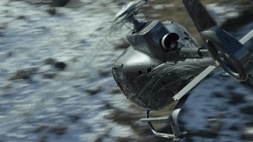 A helicopter flies over the mountain range