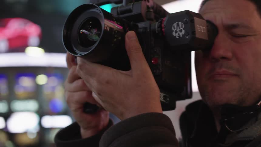 Man filming the streets on the city downtown at night