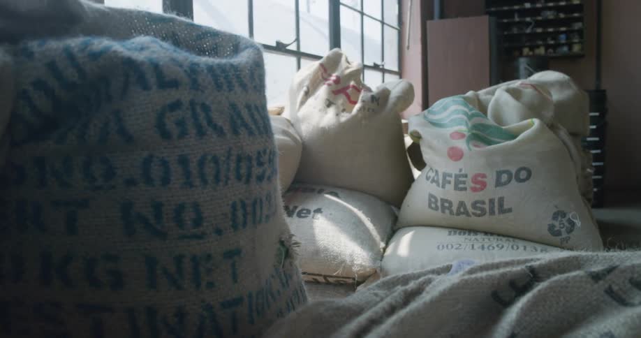 Burlap sacs filled with coffee beans stored in a warehouse