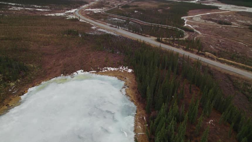 Aerial view of a road on the countryside near the mountains