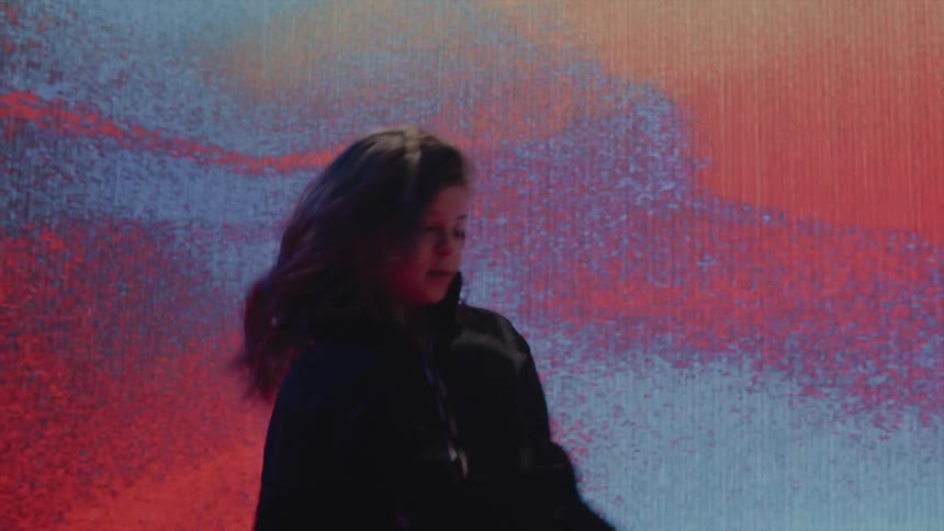 A child dancing on a stage with screens around them