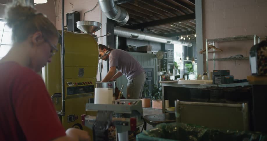 Man and woman work in backroom of coffee shop