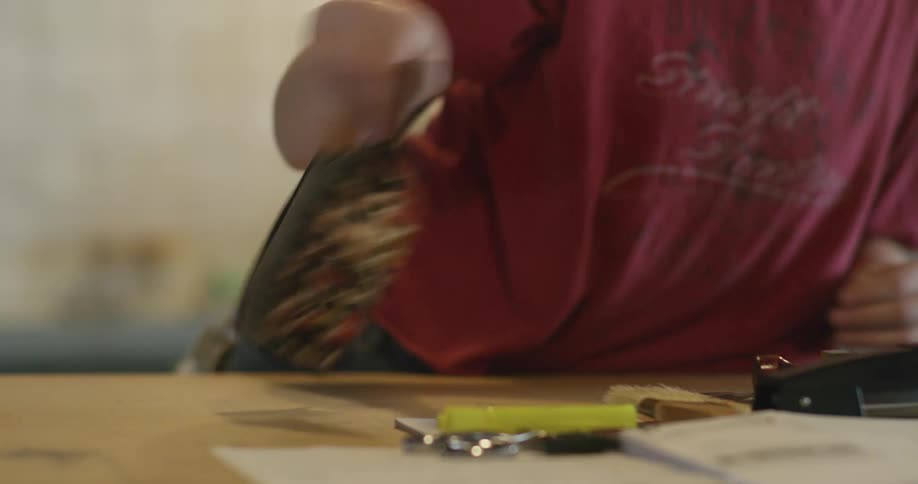 A woman moves three labeled bags off a counter