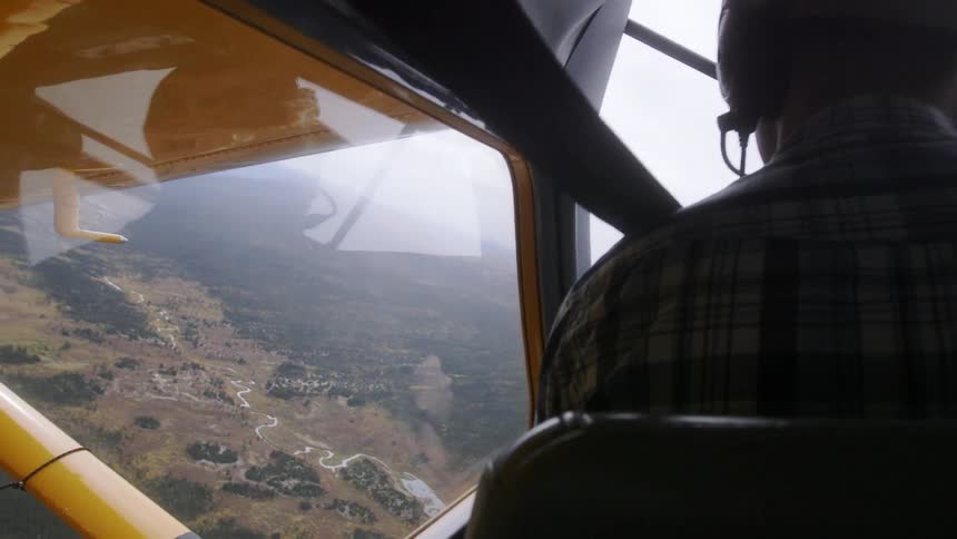 A man is piloting a plane