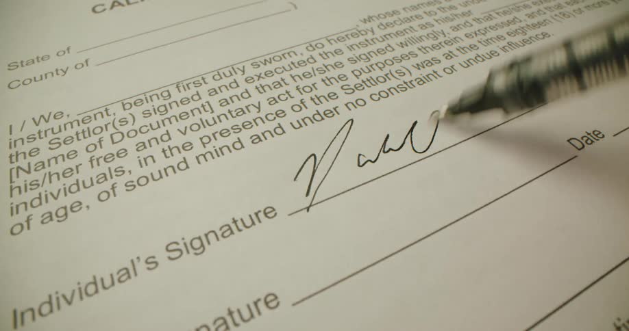 Document is being signed with a pen