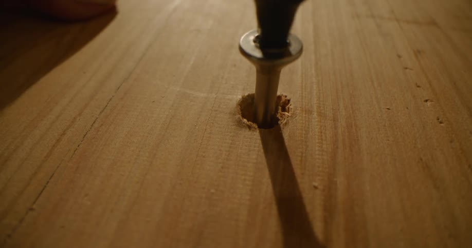 A close up of a screw going into wood