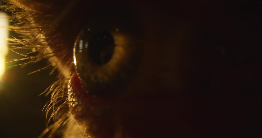 A person opening an eye