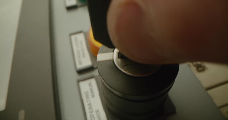 A person in a room putting a key into a machine