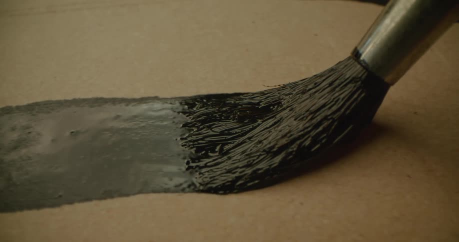 A thick black line is painted on cardboard paper