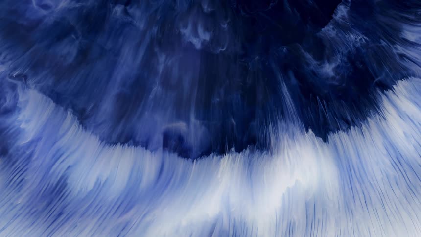 Expanding streaks of bright blue and white liquid ink
