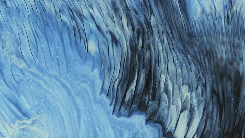 Flowing streaks of liquid bright colorful shimmering blue and white ink