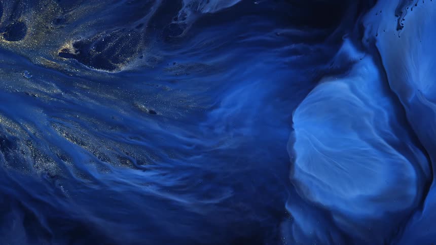 Flowing blue paint and glitter look like an alive painting