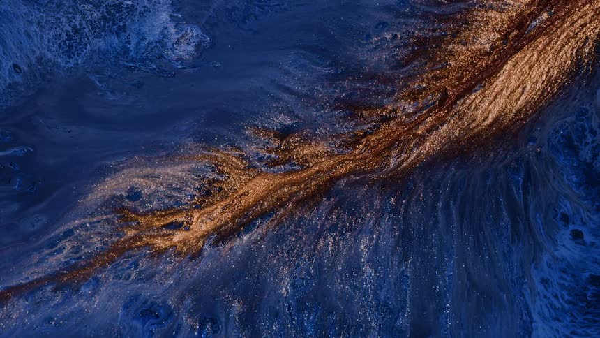 a stream of golden lava expands on blue background like in a fantasy land