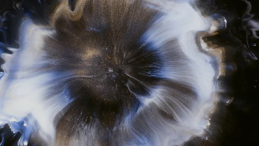 Mixed paint glittering under light spreads form flowerlike images