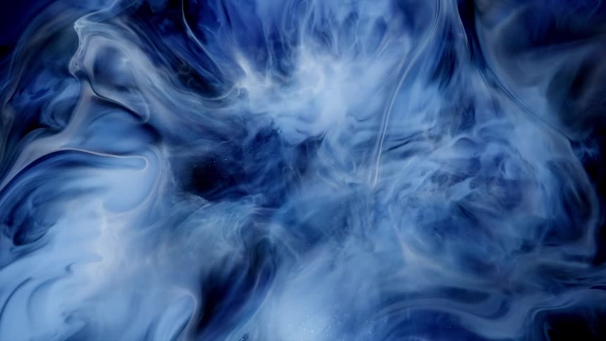Shimmering waves and traces of expanding electric blue and black ink