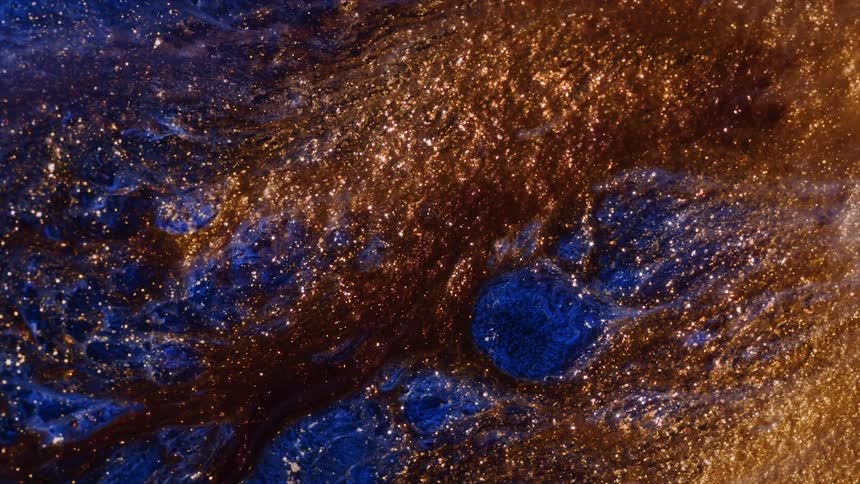 A close up of sparkles on rocks with gold and copper flakes