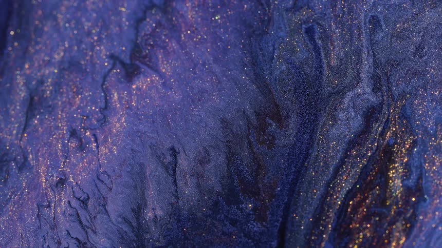 Mass of purple brown and mauve paint flows as it glitters with golden specks