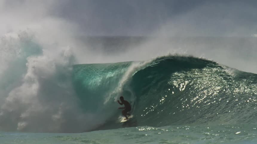 surfer getting barreled at pipeline in Hawaii