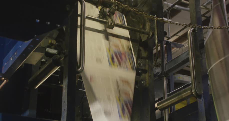 A paper press with a machine and a light above