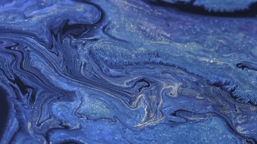 Abstract fluid material flowing with glittter and bokeh