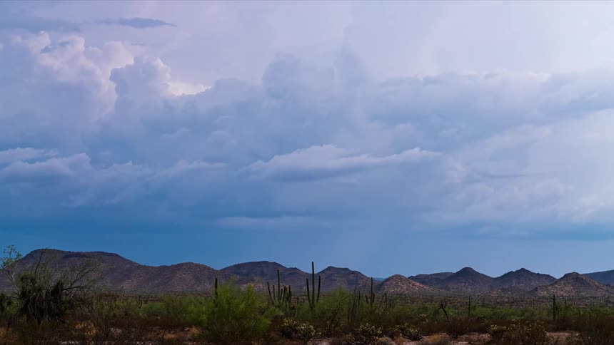 A view of a thunderstorm forming over a desert