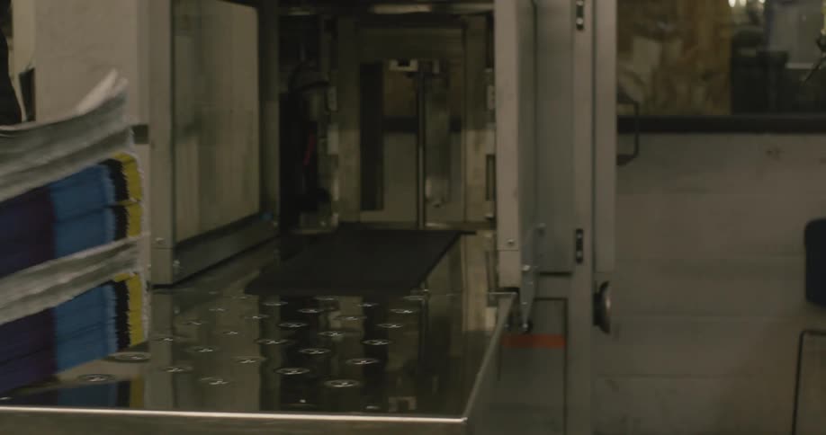 A person moving a stack of magazines