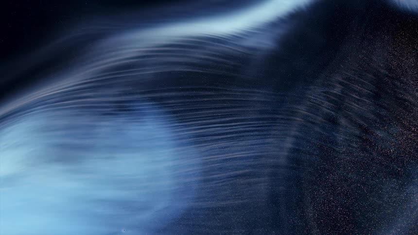 Flowing streaks of shimmering blue and white ink