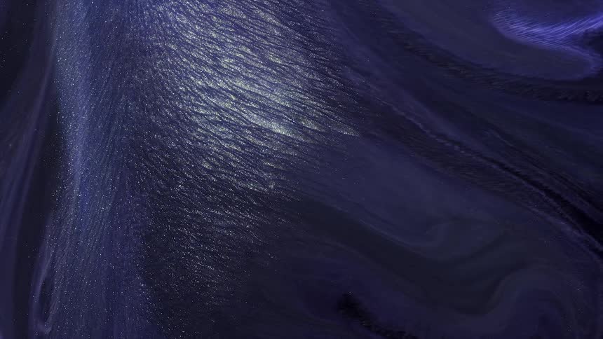 A organic and artsy view of water flowing with glitter and ink