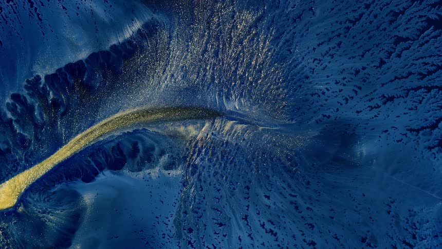 A watery stream of shimmering paint creates a stream in an abstract scenery