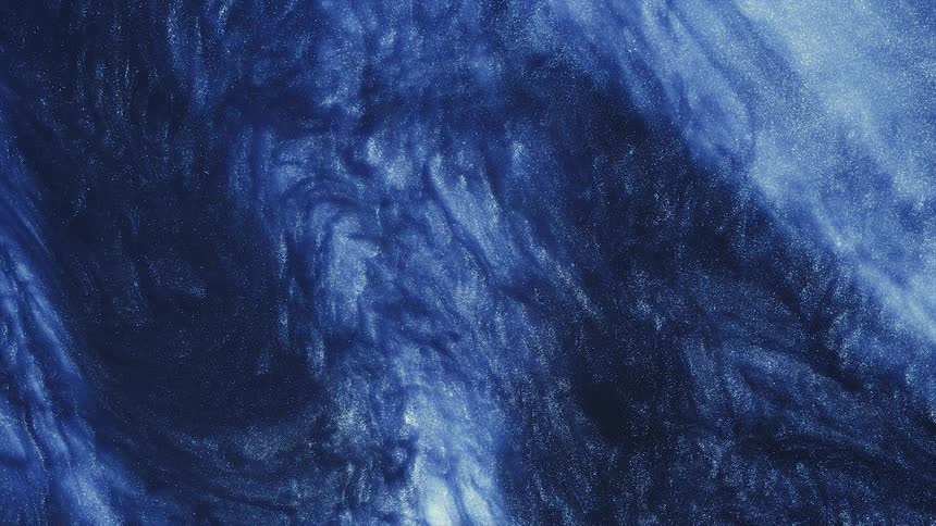 Mixture of white blue and golden particles flow