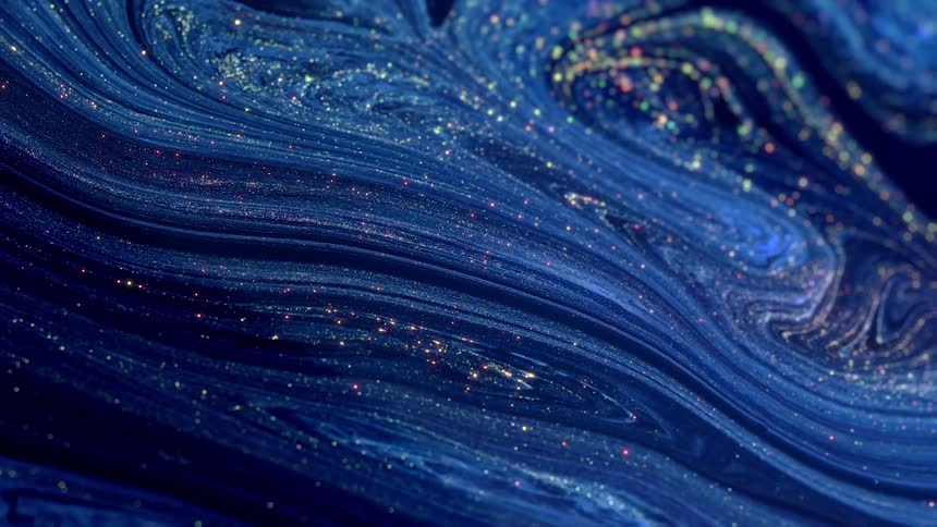 Gold glitter shimmers throughout blue paint and marbles