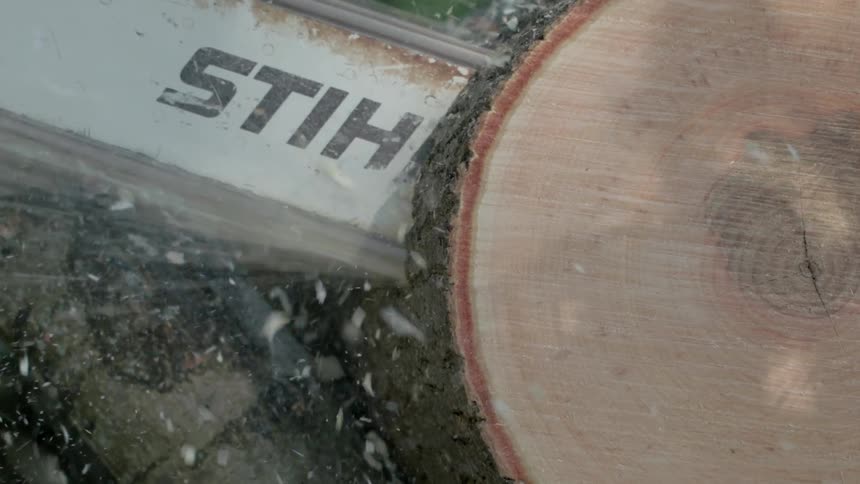 A chainsaw is cutting through a log