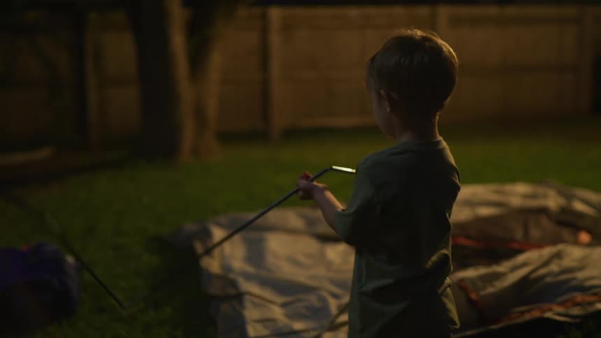Father and son building a tent