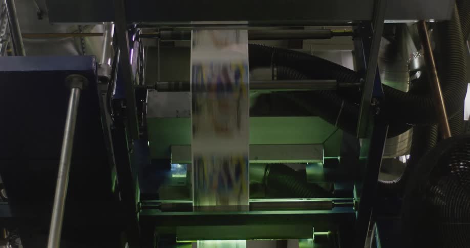 Long stream of paper runs through printing press