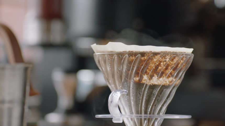 A steaming hot cup of coffee is sitting on a table
