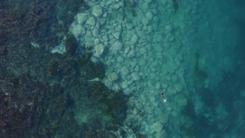 A view of a person swimming in the ocean
