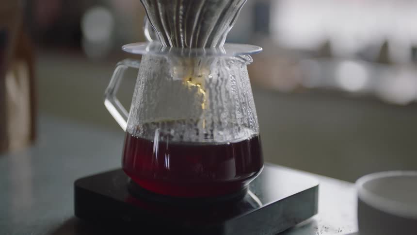 Coffee brewing on a jar in the counter top of a restaurant
