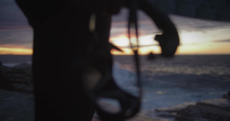 Ocean waves are moving towards the coast at dusk