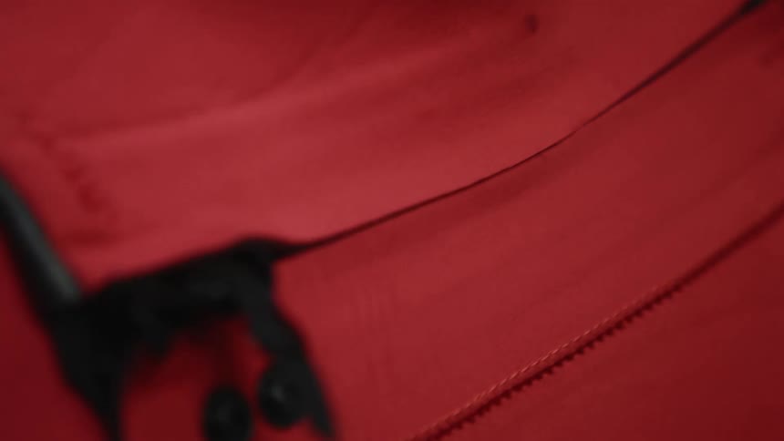 A person closing a zipper on a piece of clothing