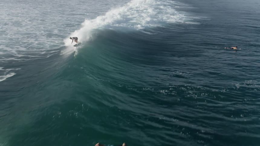 People are surfing waves in the ocean during the day