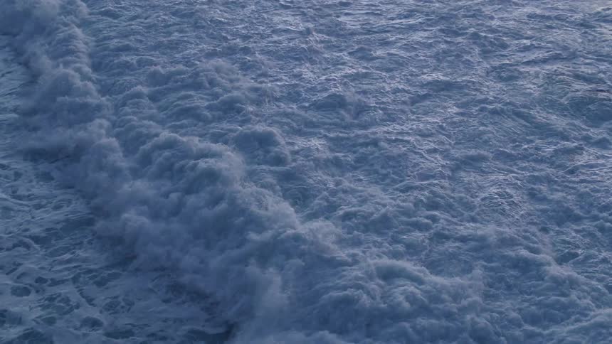 Waves are splashing and foaming as they roll in