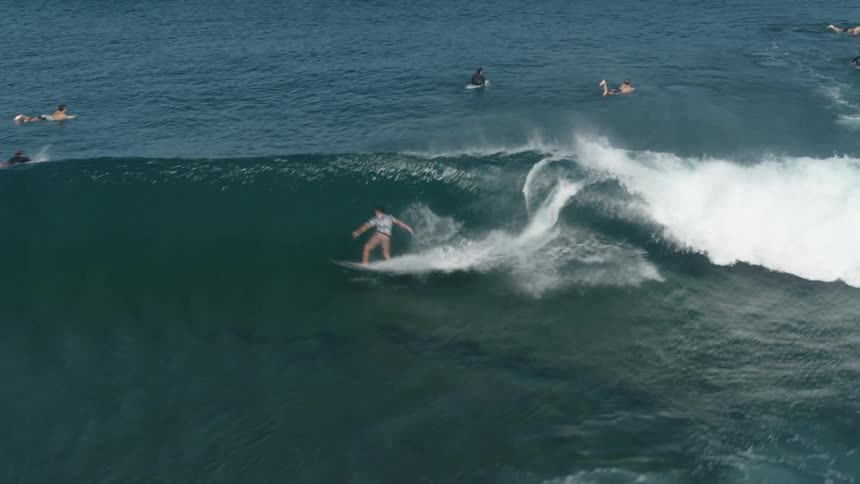 A group of people surfing on waves on the ocean
