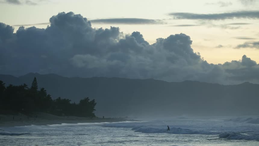 A man that is surfing outdoors on the ocean