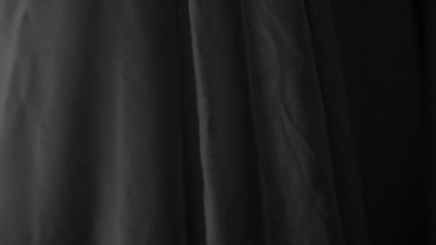 A white curtain rustles at night