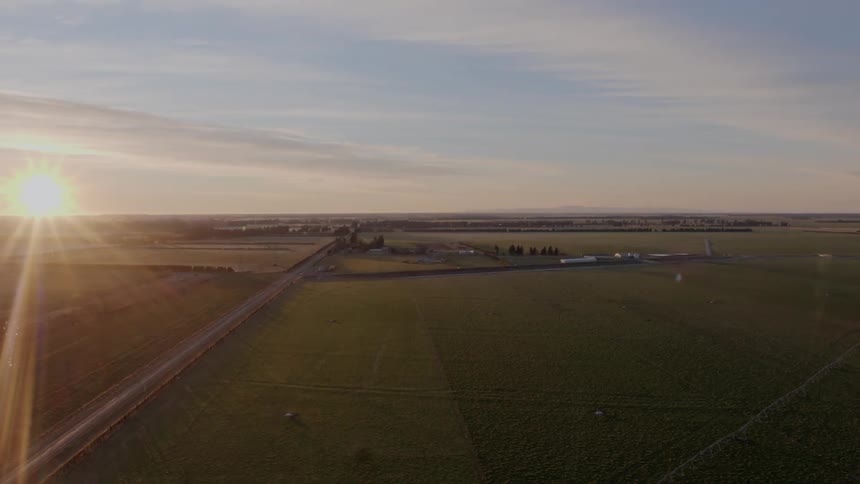 A road through a vast countryside during the day