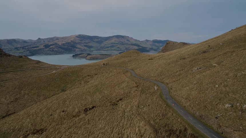 An aerial view of some hills with a lake in the middle
